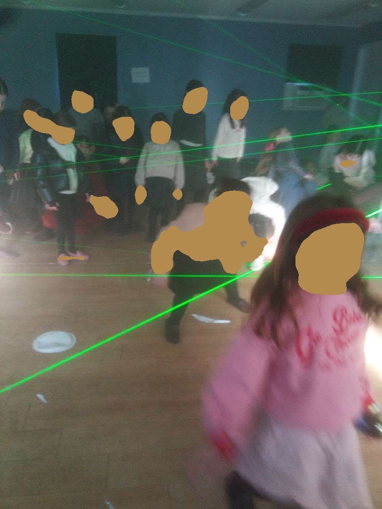 Girls dancing under green laser lights