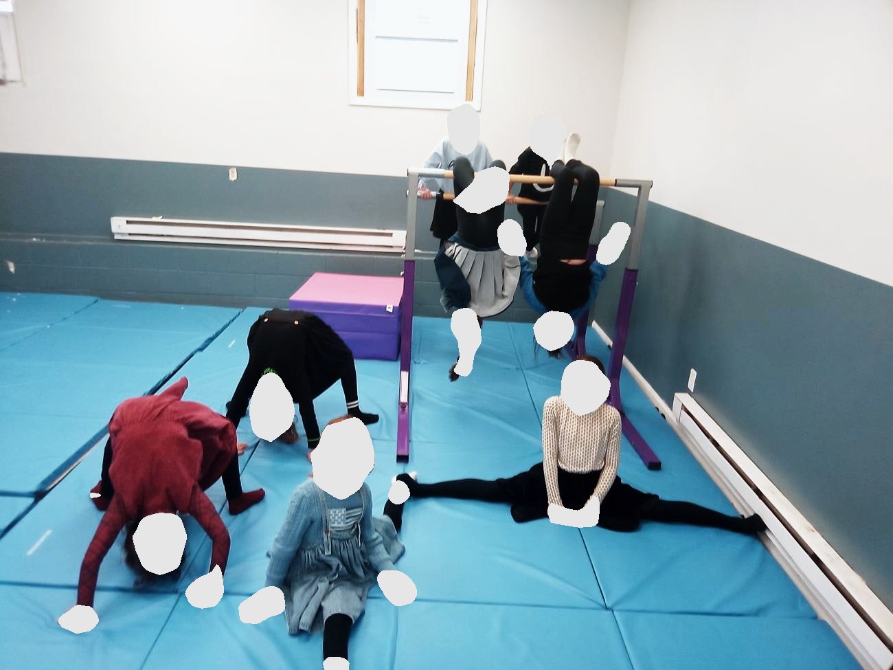 Girls stretching, doing splits and bridges in the gymnastics room