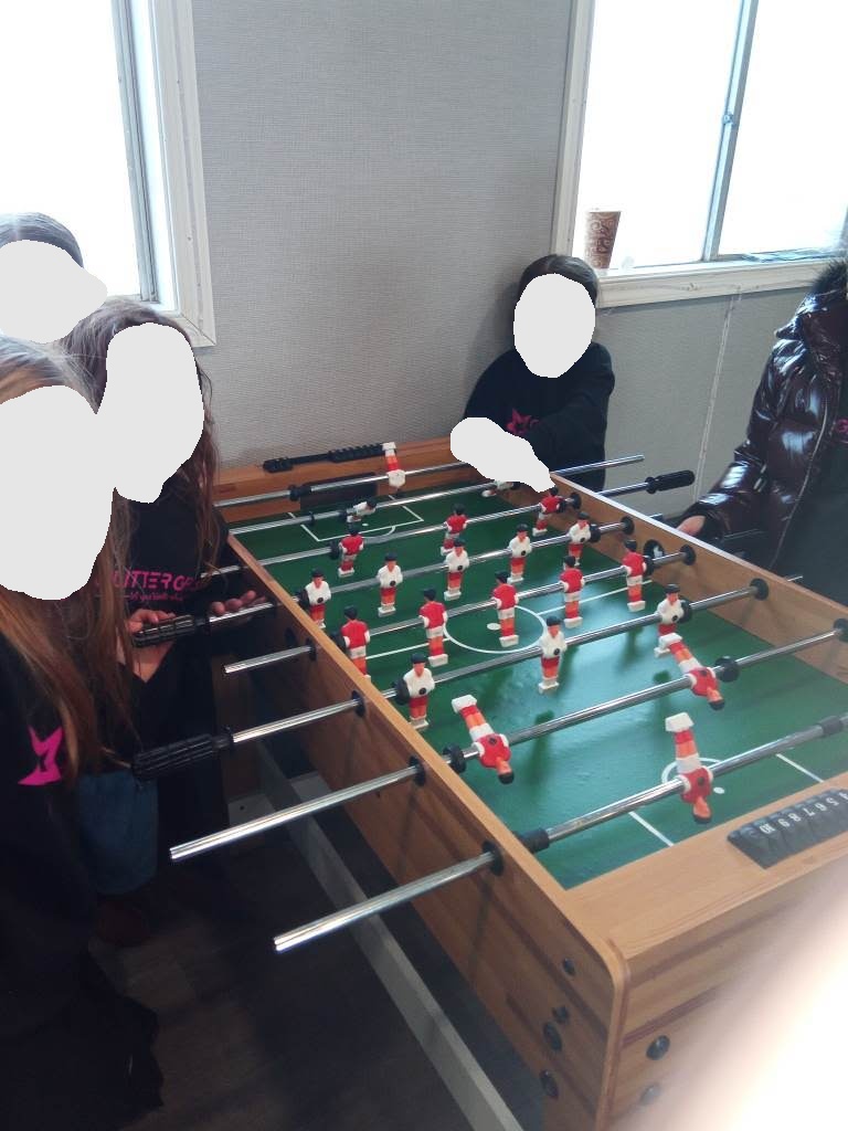 Girls playing foosball in the game room